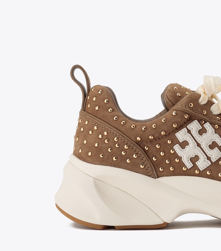 Tory Burch designer sneakers Good Luck Studded Trainer in ALCE / GOLD angle
