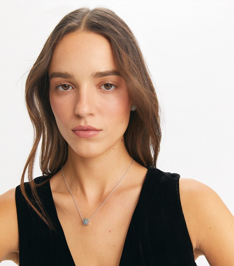 Tory Burch designer necklaces Guilloche Flower Pendant in Tory Silver / Sky accessory on model