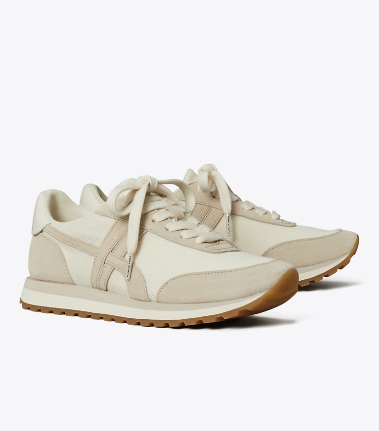 Tory Burch designer sneakers Hank Sneaker in NEW IVORY / CALCARE / TITANIUM WHITE angle