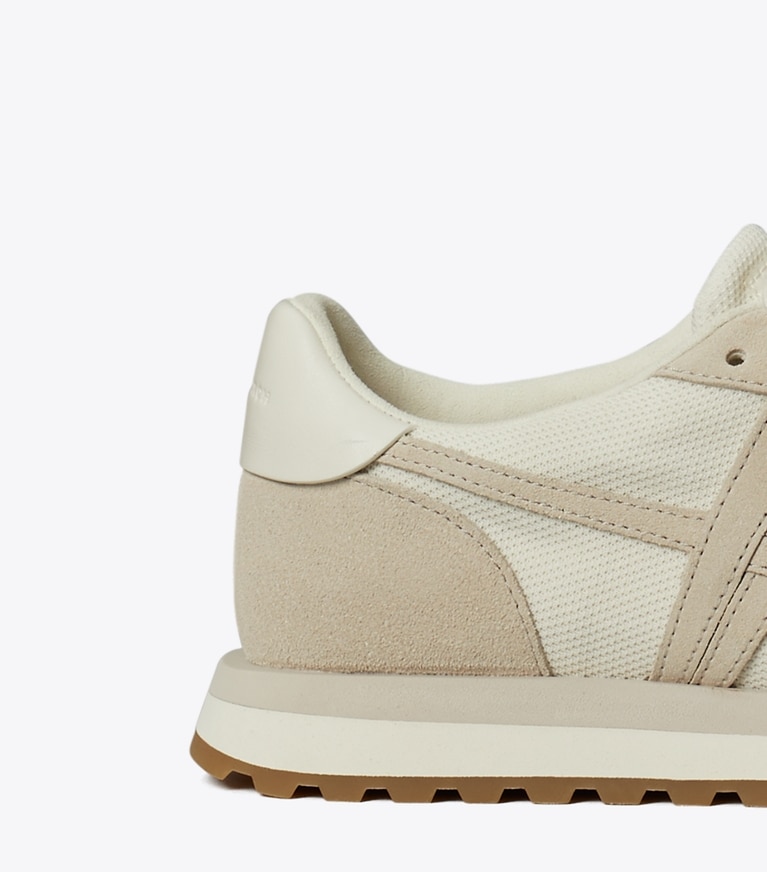 Tory Burch designer sneakers Hank Sneaker in NEW IVORY / CALCARE / TITANIUM WHITE angle