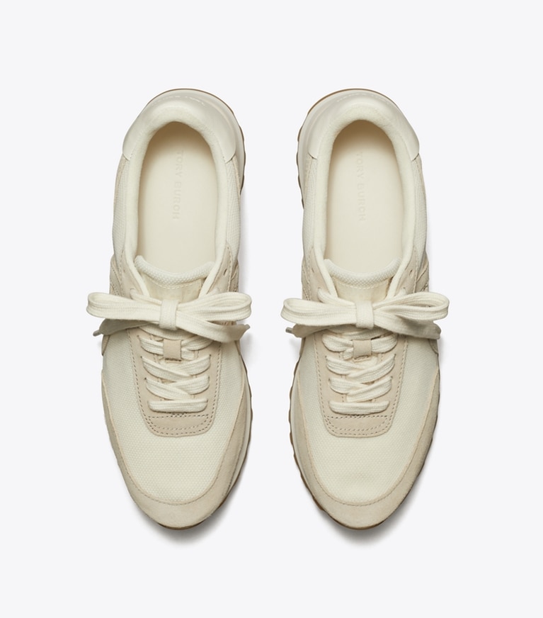 Tory Burch designer sneakers Hank Sneaker in NEW IVORY / CALCARE / TITANIUM WHITE angle