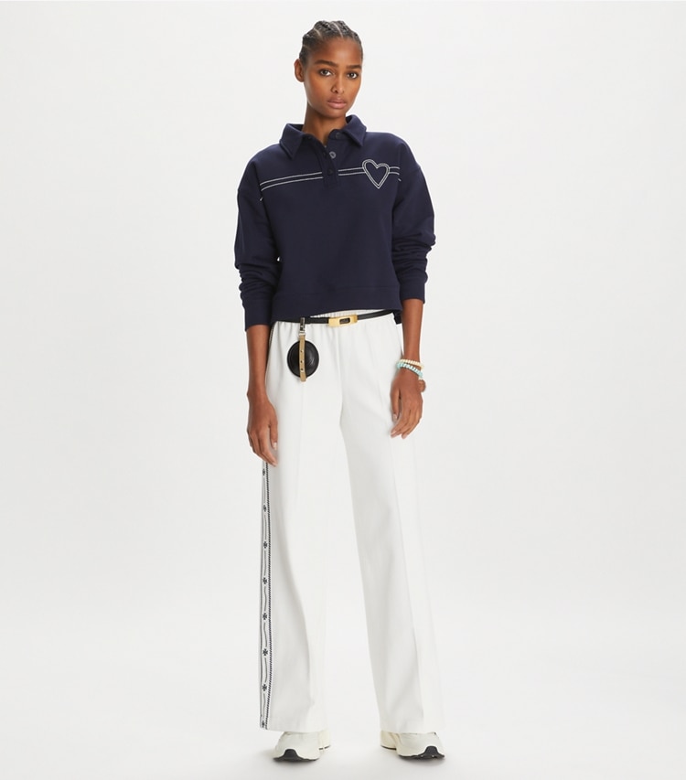 Tory Sport designer sweaters Heart Pickstitch Cotton Polo in Medium Navy on model front