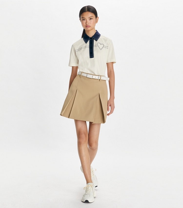 Tory Sport designer tops Heart Pickstitch Cotton Polo in New Ivory / Tory Navy on model front