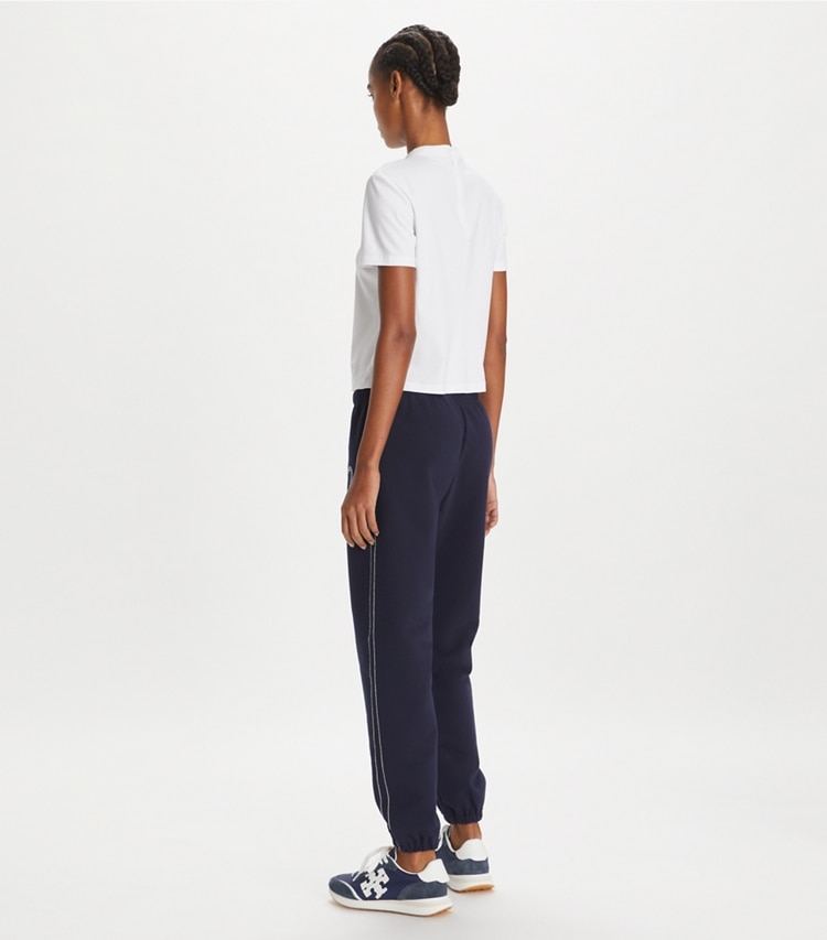 Tory Sport designer bottoms Heart Pickstitch French Terry Sweatpant in Medium Navy on model back