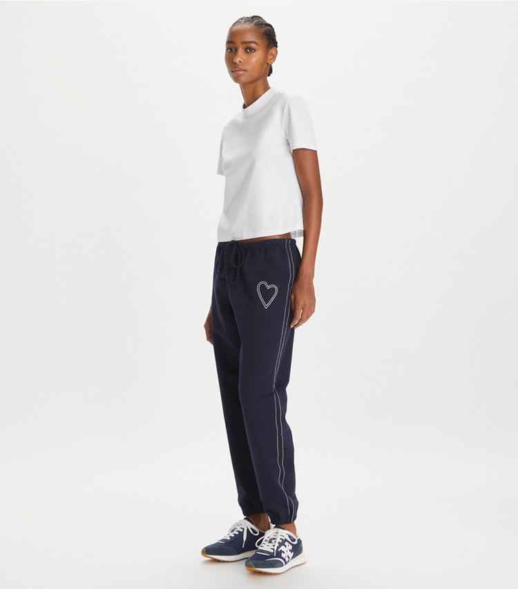 Tory Sport designer bottoms Heart Pickstitch French Terry Sweatpant in Medium Navy on model front