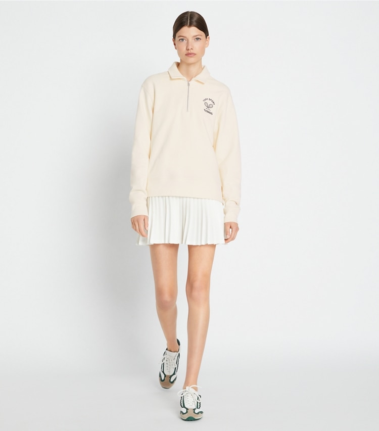 Tory Sport designer tops Heavy French Terry Half-Zip Tennis Pullover in Ivory Pearl / Tory Navy on model front