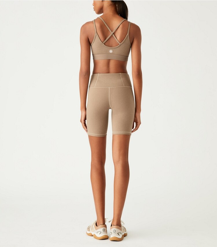 Tory Sport designer bottoms High-Rise Compression Mélange Bike Short in Natural Heather on model back