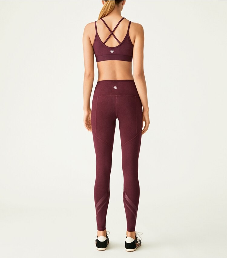 Tory Sport designer bottoms High-Rise Compression Mélange Side-Pocket Chevron Legging in Winetasting Heather on model back