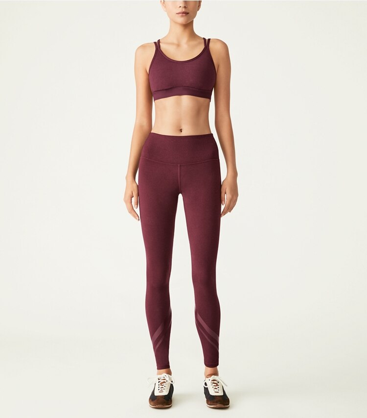 Tory Sport designer bottoms High-Rise Compression Mélange Side-Pocket Chevron Legging in Winetasting Heather on model front