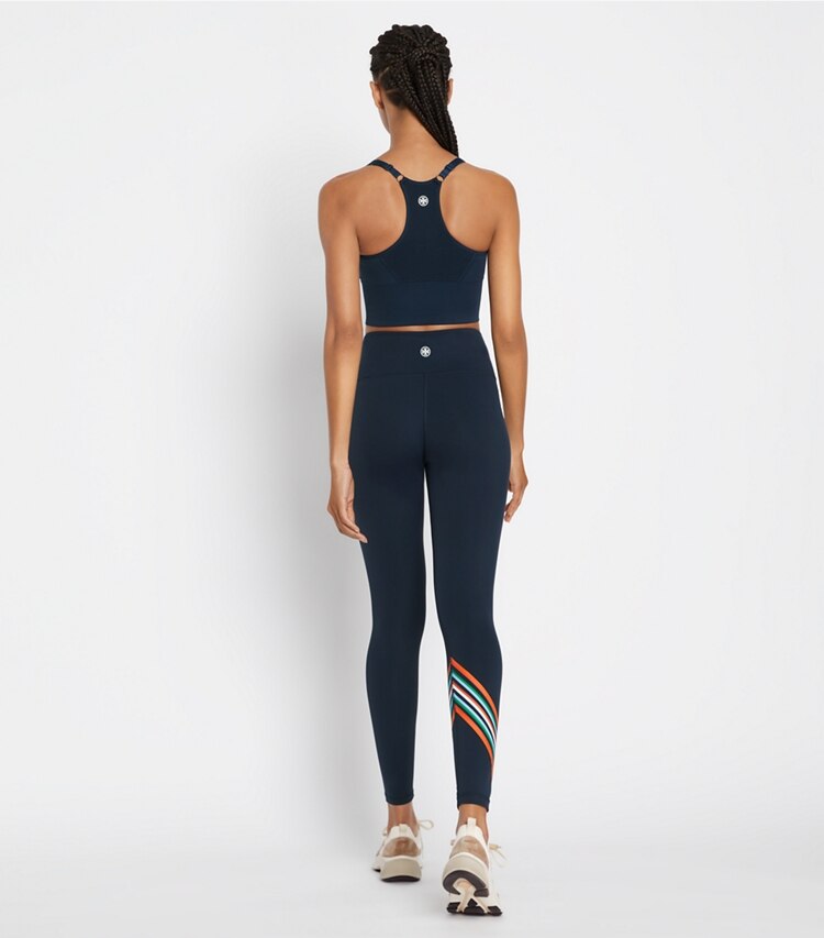 Tory Sport designer bottoms High-Rise Weightless Spectrum Chevron Legging in Tory Navy / Red on model back