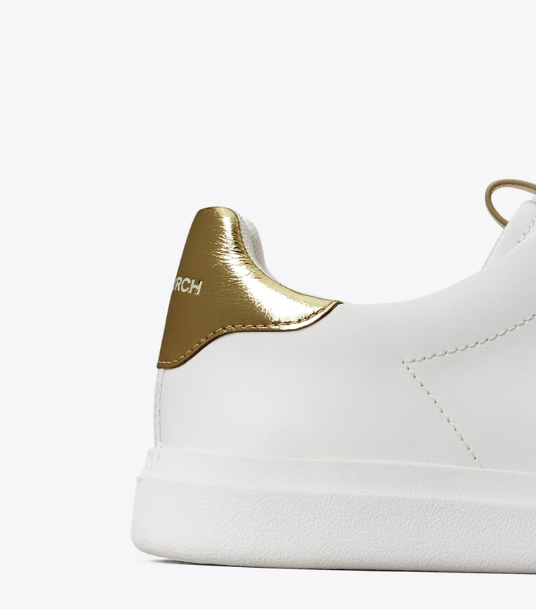 Tory Burch designer sneakers Howell Court Sneaker in Titanium White / Spark Gold angle