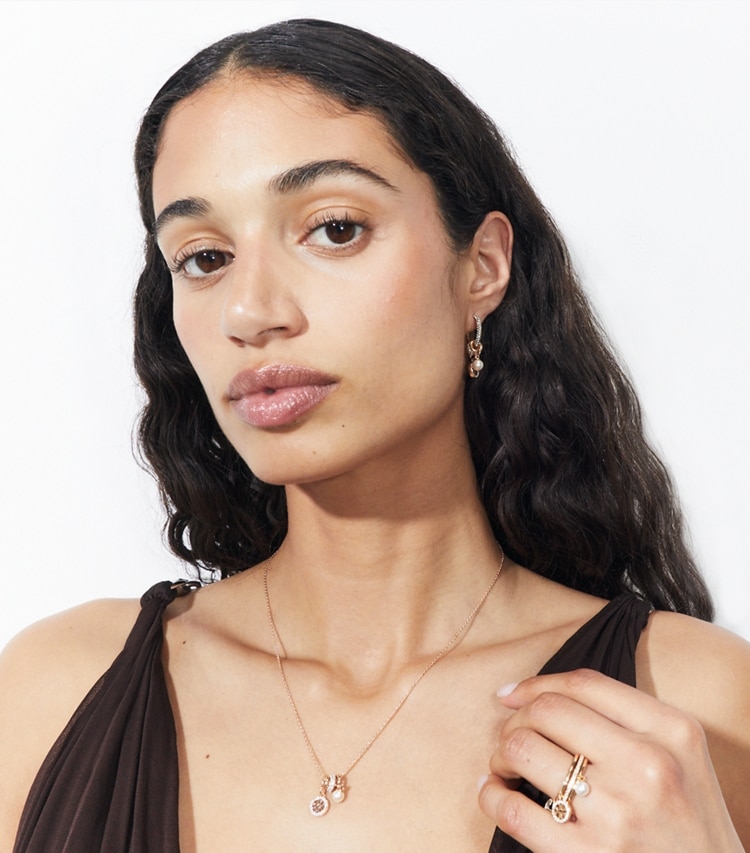 Tory Burch designer earrings Icon Pavé Charm Earrings in Tory Gold / Crystal / Pearl accessory on model