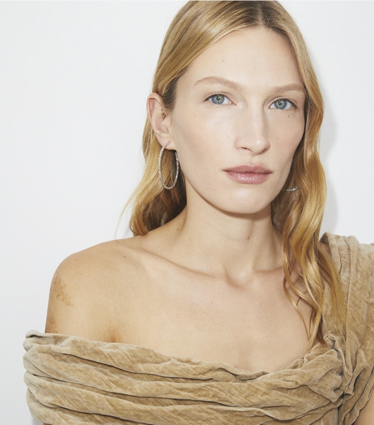 Tory Burch designer earrings Icon Pavé Hoop Earrings in Tory Gold / Crystal accessory on model