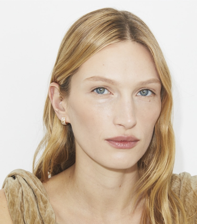 Tory Burch designer earrings Icon Pavé Huggie Earrings in Tory Gold / Crystal accessory on model