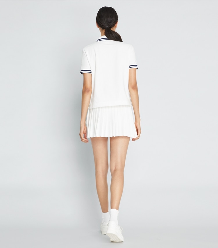 Tory Sport designer bottoms Jacquard Performance Jersey Pleated Overlay Skirt in Snow White on model back