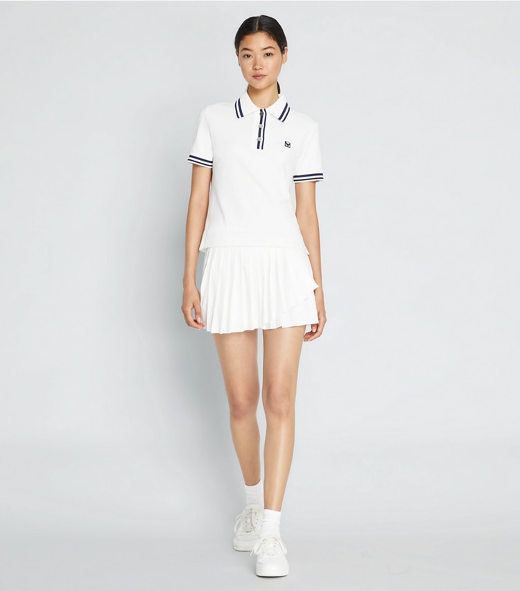 Tory Sport designer bottoms Jacquard Performance Jersey Pleated Overlay Skirt in Snow White on model front