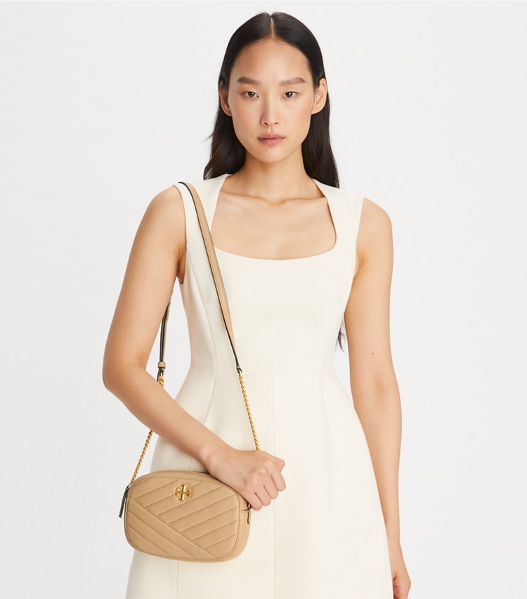 Tory Burch designer crossbody bags Kira Chevron Camera Bag in Desert Dune accessory on model