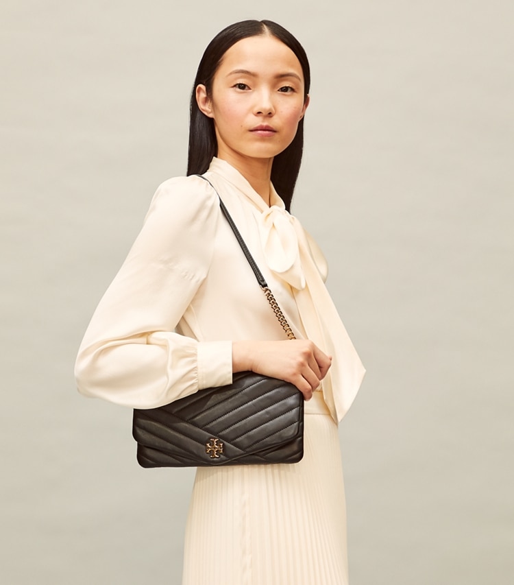 Tory Burch designer clutches Kira Chevron Clutch in Black accessory on model