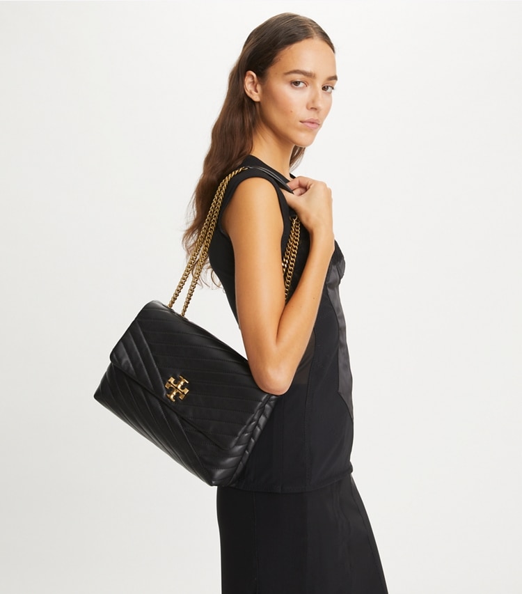Tory Burch designer shoulder bags Kira Chevron Convertible Shoulder Bag in Black / Rolled Brass accessory on model