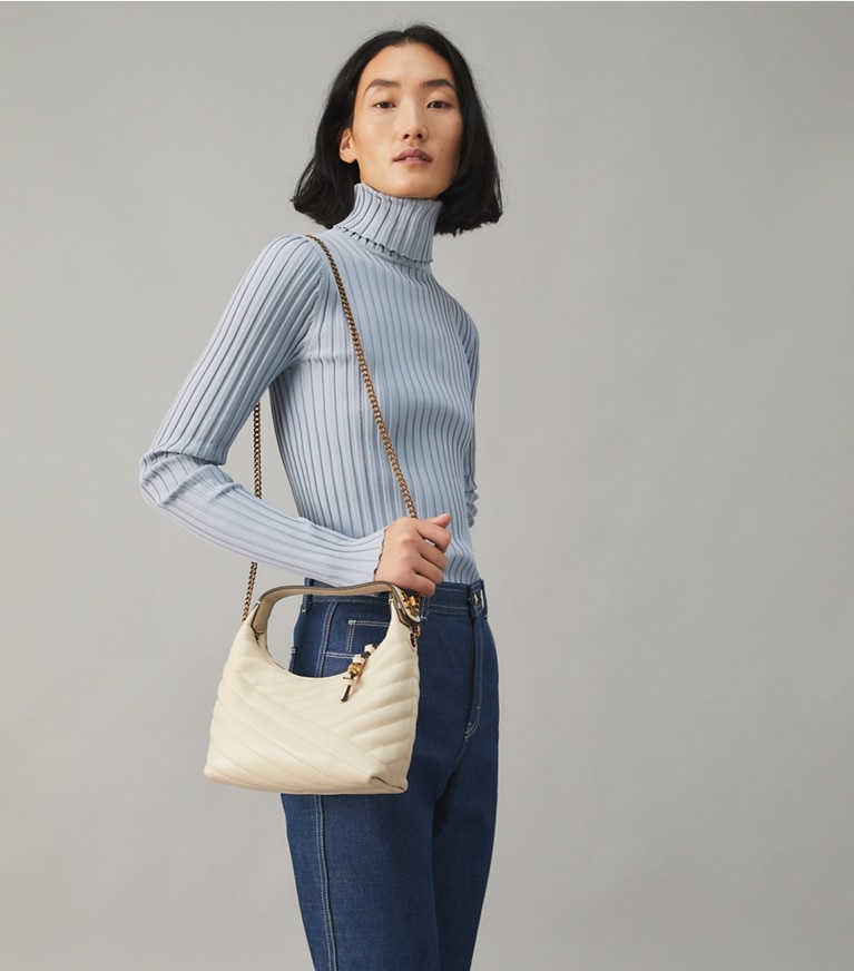 Tory Burch designer shoulder bags Kira Chevron Crescent Bag in NEW CREAM / Rolled Gold accessory on model