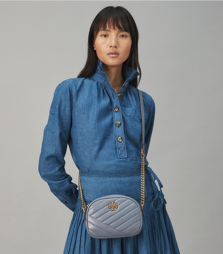 Tory Burch designer crossbody bags Kira Chevron Small Camera Bag in RAINWATER / Dark Gold accessory on model