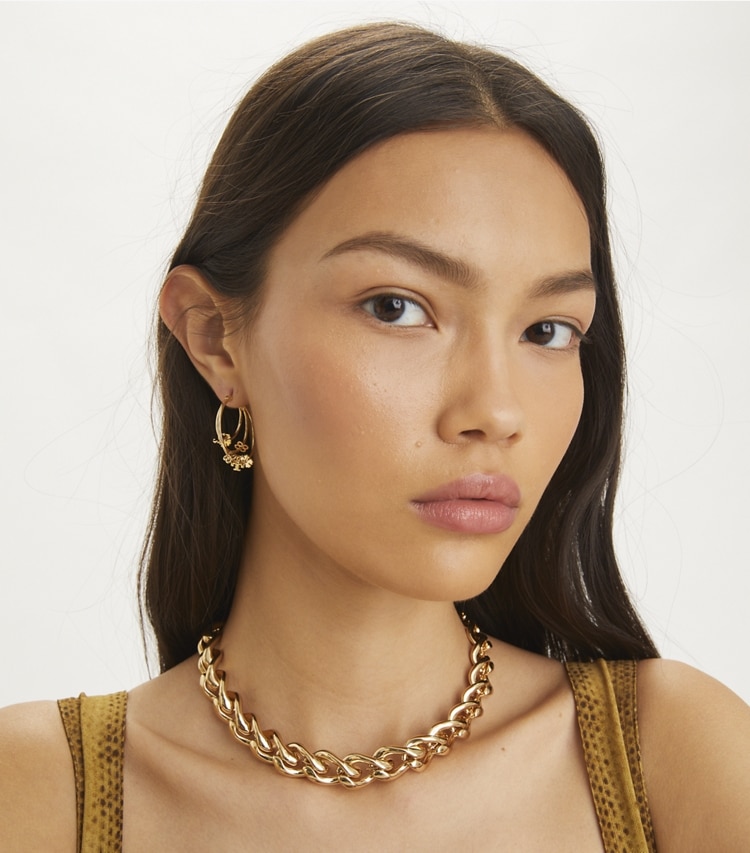 Tory Burch designer earrings Kira Clover Hoop Earrings in Tory Gold accessory on model