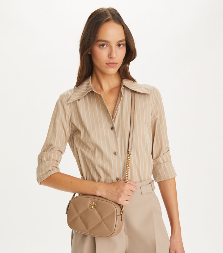 Tory Burch designer crossbody bags Kira Diamond Quilt Camera Bag in Taupe Oak accessory on model