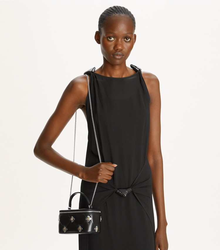 Tory Burch designer mini bags Kira Diamond Quilt Clover Vanity Case in Black accessory on model