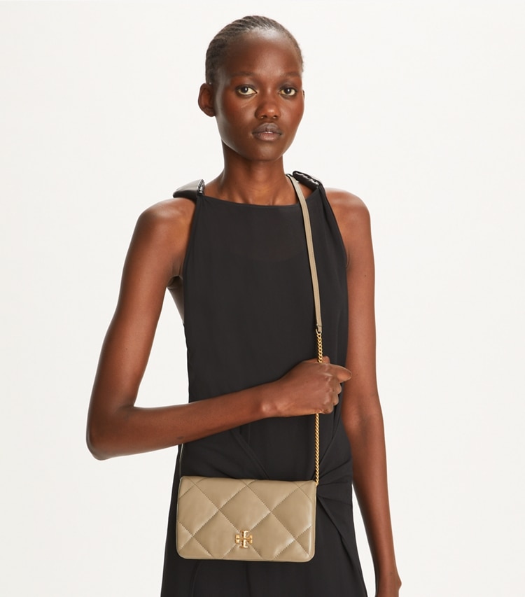 Tory Burch designer mini bags Kira Diamond Quilt Crossbody in Taupe Oak accessory on model