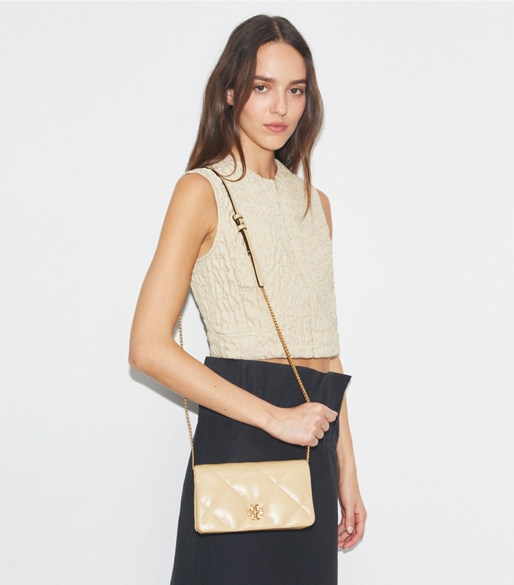 Tory Burch designer mini bags Kira Diamond Quilt Crossbody in Vanilla Soft Serve accessory on model