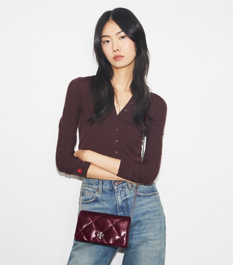 Tory Burch designer mini bags Kira Diamond Quilt Distressed Crossbody in Dark Carmine accessory on model