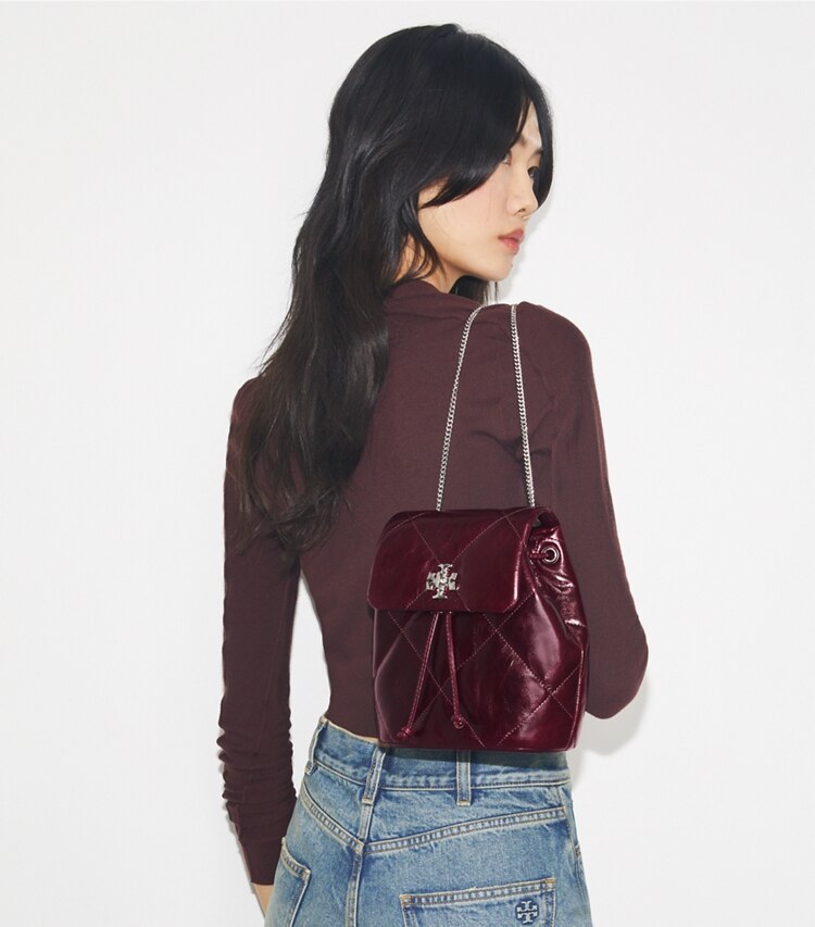 Tory Burch designer backpacks Kira Diamond Quilt Distressed Mini Backpack in Dark Carmine accessory on model