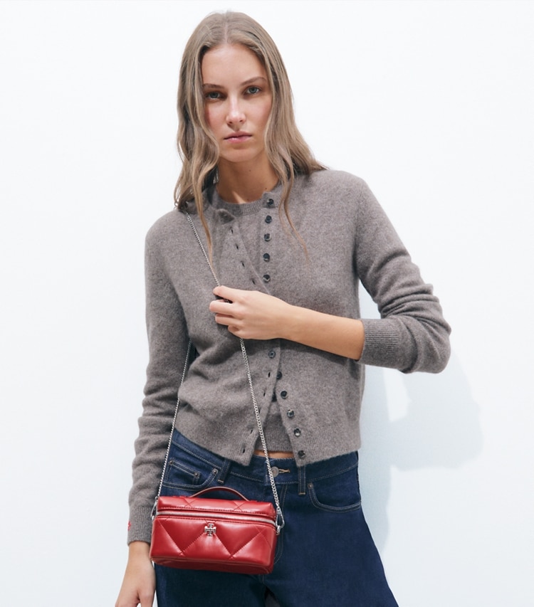 Tory Burch designer crossbody bags Kira Diamond Quilt East-West Vanity Case in Red accessory on model