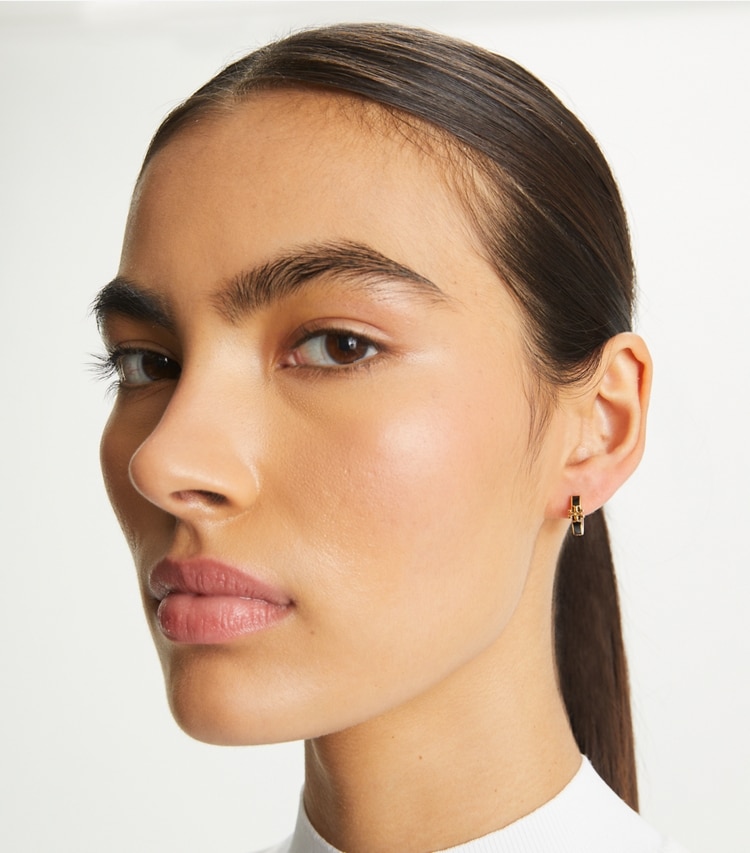 Tory Burch designer earrings Kira Enamel Huggie Earring in Tory Gold / Black accessory on model