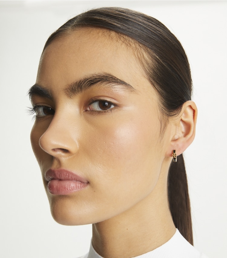 Tory Burch designer earrings Kira Enamel Huggie Earrings in Tory Gold / Black accessory on model