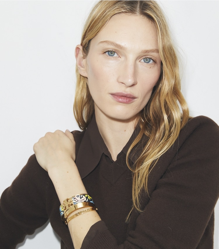 Tory Burch designer bracelets Kira Enamel Wide Bangle in Tory Gold / Acrobats Pink accessory on model