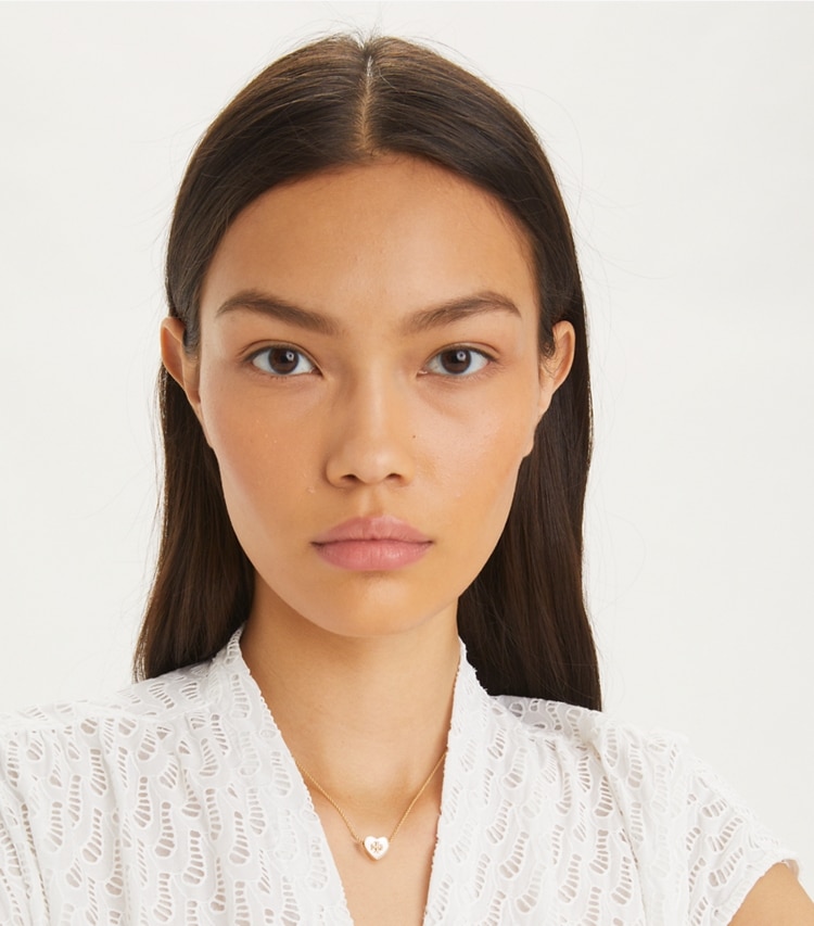 Tory Burch designer necklaces Kira Heart Pendant Necklace in Tory Gold / Pink additional on model