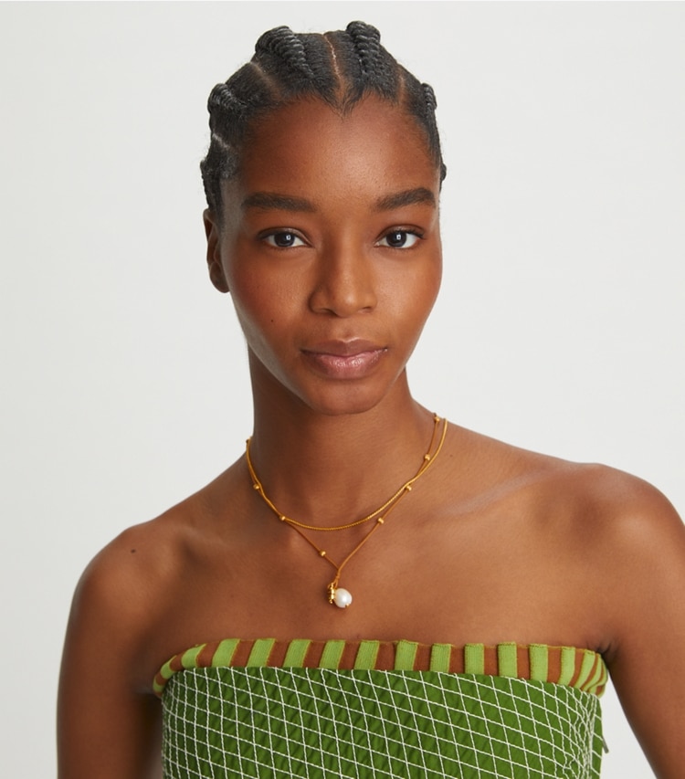 Tory Burch designer necklaces Kira Pearl Pendant Necklace in Rolled Brass / Vachetta / Ivory accessory on model