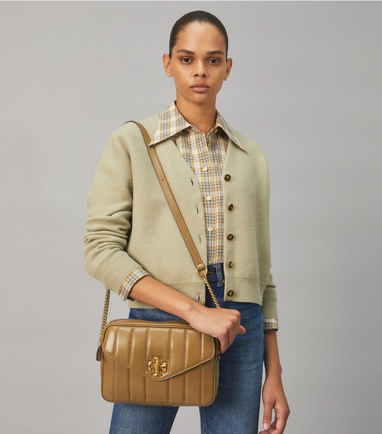 Tory Burch designer crossbody bags Kira Quilted Camera Bag in TOASTED SESAME accessory on model