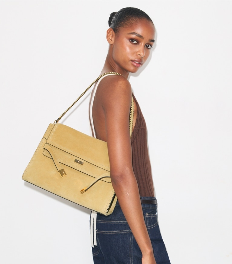 Tory Burch designer shoulder bags Large Lee Radziwill Suede Shoulder Bag in Butter accessory on model
