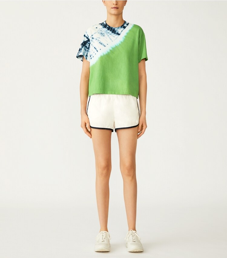 Tory Sport designer bottoms Lightweight Nylon Track Short in Snow White on model front