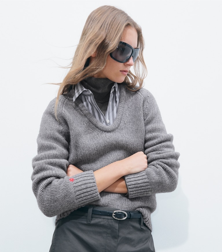 Tory Burch designer sweaters Merino Wool U-Neck Sweater in Cloudy Gray Melange on model detail