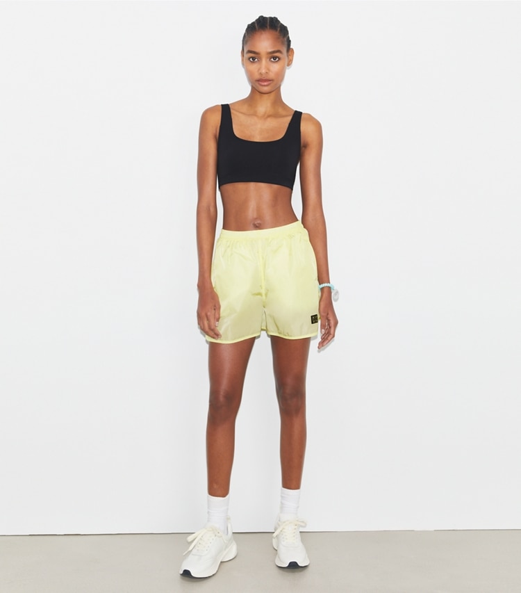 Tory Sport designer bottoms Mesh-Panel Nylon Short in Lumen on model front