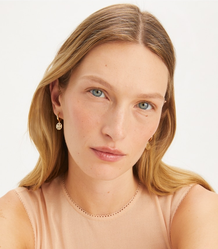 Tory Burch designer earrings Miller Huggie Hoop Earring in Tory Gold accessory on model