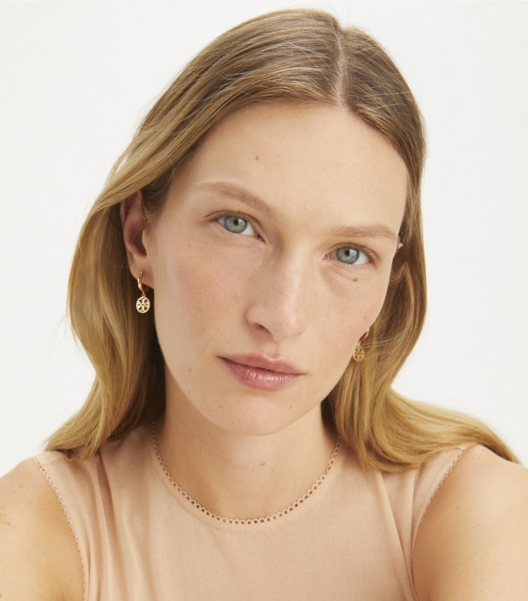 Tory Burch designer earrings Miller Huggie Hoop Earrings in Tory Gold accessory on model