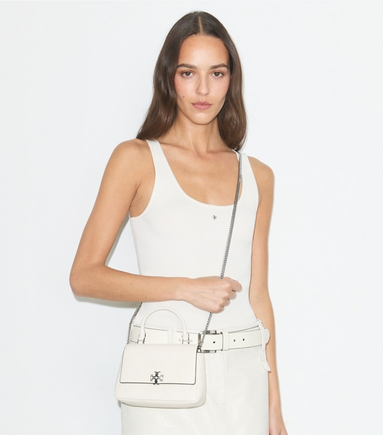 Tory Burch designer crossbody bags Mini Charlie Quilted Top-Handle Crossbody in Light Cream accessory on model