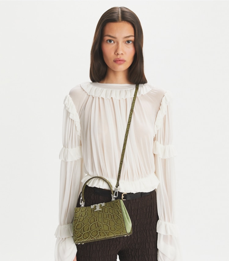 Tory Burch designer crossbody bags Mini Eleanor Croc-Embossed Satchel in Soft Ivy accessory on model