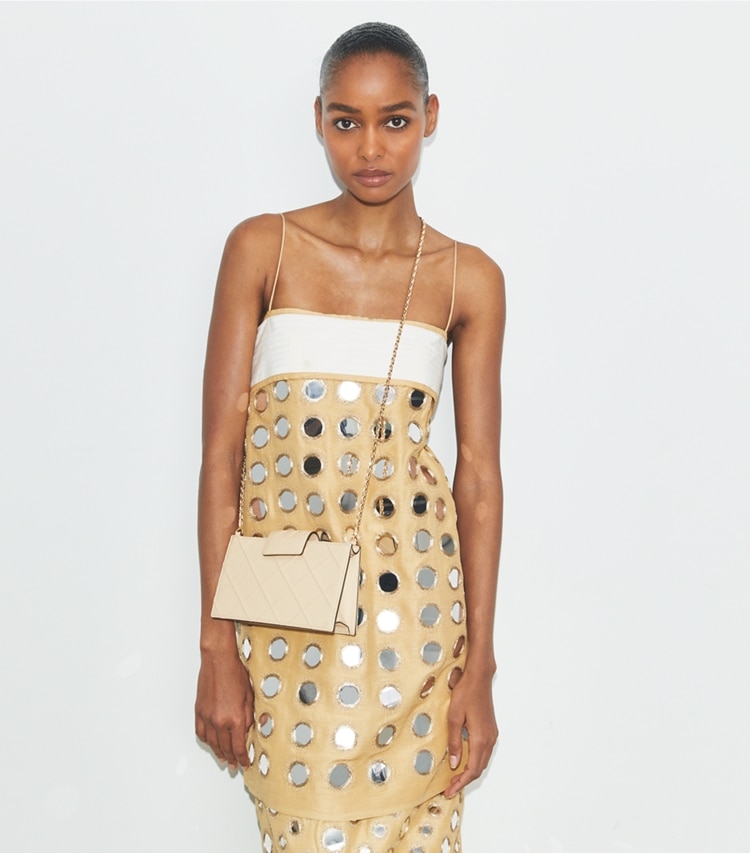 Tory Burch designer mini bags Mini Fleming Soft Crossbody in Vanilla Soft Serve accessory on model