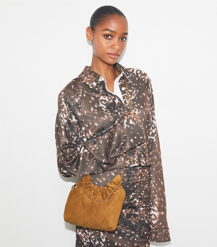 Tory Burch designer crossbody bags Mini Fleming Soft Suede Hobo Bag in CHICORY BROWN accessory on model