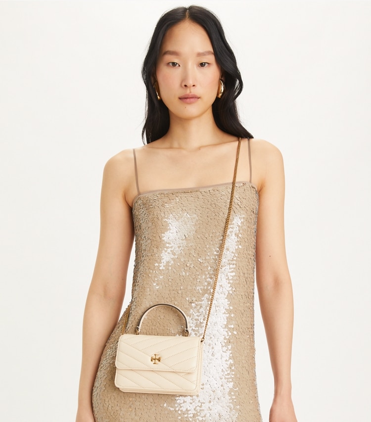 Tory Burch designer mini bags Mini Kira Chevron Top Handle Crossbody in New Cream accessory on model